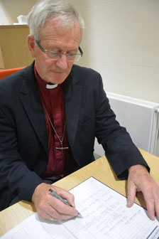 Bishop David signs the Register